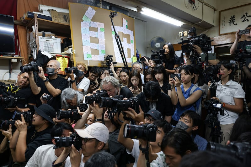 Reporters photograph the press conference where Chan Po-ying, Chair of Hong Kong’s League of Social Democrats, along with party members Jimmy Sham, Raphael Wong, and Figo Chan, announce the party’s dissolution in Hong Kong, June 29, 2025.